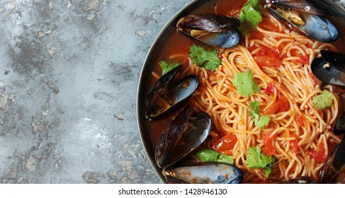 Pasta Spaghetti With Mussels, Tomato Sauce. Sea Food Meal. Mussels Marinara. Typical Dish Of Italian Pasta.  Top View.