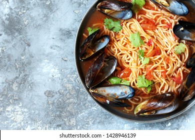 Pasta Spaghetti With Mussels, Tomato Sauce. Sea Food Meal. Mussels Marinara. Typical Dish Of Italian Pasta.  Top View.