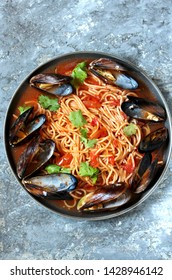 Pasta Spaghetti With Mussels, Tomato Sauce. Sea Food Meal. Mussels Marinara. Typical Dish Of Italian Pasta.  Top View.