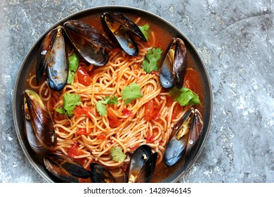 Pasta Spaghetti With Mussels, Tomato Sauce. Sea Food Meal. Mussels Marinara. Typical Dish Of Italian Pasta.  Top View.