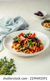 Pasta With Spinach And Chick Peas In Red Sauce