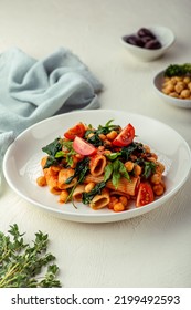 Pasta With Spinach And Chick Peas In Red Sauce