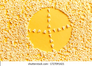 Pasta Text Of Macaroni Letters In A Round Macaroni Frame On A Yellow Background.