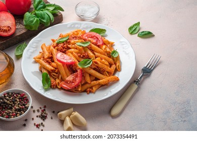 Pasta With Tomato Sauce, Tomatoes And Basil On A Light Gray Background. Italian Dish. Side View, Copy Space.