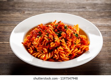 Pasta With Tomato Sauce And Vegtables On Wooden Table