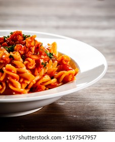 Pasta With Tomato Sauce And Vegtables On Wooden Table