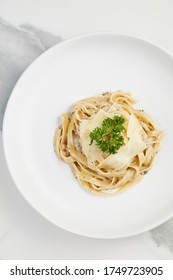 Pasta With Truffle Cream Sauce, Tagliatelle Creamy White Wine Sauce In White Plate On White Marble Background