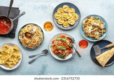 Pasta variety. Italian food and drinks, overhead flat lay shot. Spaghetti marinara, mushroom pappardelle, seafood pasta, wine, tomato sauce, Parmesan