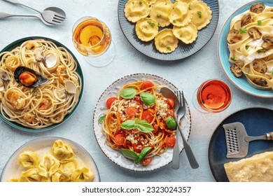 Pasta variety. Italian food and drinks, overhead flat lay shot. Spaghetti marinara, mushroom pappardelle, seafood pasta, wine, Parmesan cheese - Powered by Shutterstock