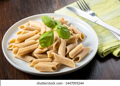 pasta, wholemeal penne - stock photo