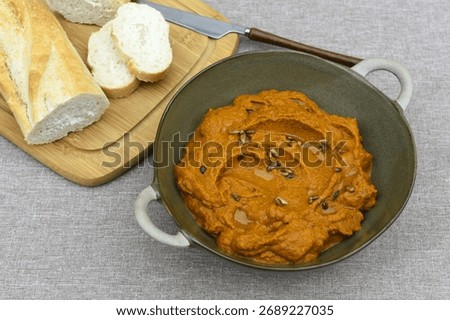 A paste made from boiled carrots, roasted sunflower seeds, garrlic,
spoon of tomato pure and olive oil.