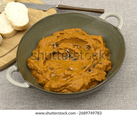 A paste made from boiled carrots, roasted sunflower seeds, garlic, spoon of tomato pure and olive oil. 
