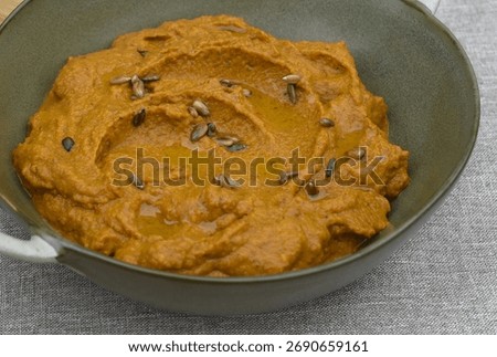 A paste made from boiled carrots, roasted sunflower seeds, garlic, spoon of tomato pure and olive oil. 
