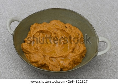 A paste made from boiled carrots, roasted sunflower seeds, garlic, spoon of tomato pure and olive oil. 
