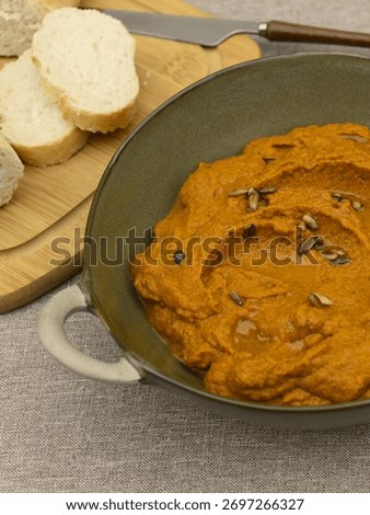 A paste made from boiled carrots, roasted sunflower seeds, garlic, spoon of tomato pure and olive oil. 
