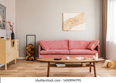 Pastel Abstract Painting On Beige Wall Behind Velvet Pink Settee In Simple Living Room