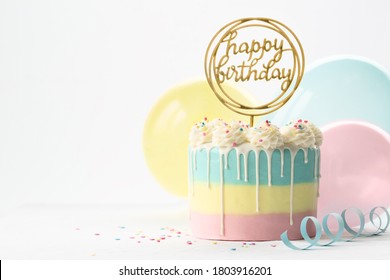 Pastel Birthday Cake With Drip Icing And Balloons