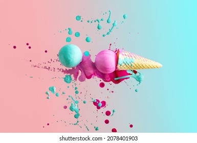 Pastel blue and pink painted balls composed with ice cream cone in paint splash. Minimal summer holiday layout .