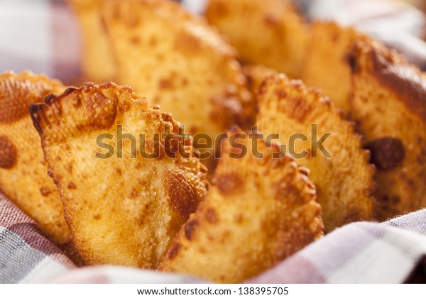Pastel,\
a Brazilian snack, with a bar in the\
background.