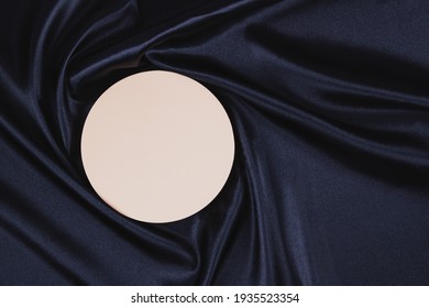 Pastel circle platform podium on black color background with drapery and wavy folds of silk satin material