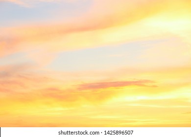 Pastel Clouded Sky On The Sunset In Yellow And Orange Colors