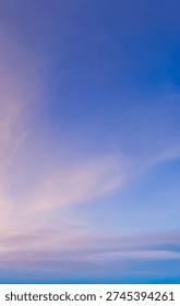Pastel cloudscape sky at sunset with soft pink and blue gradients creating a calm, serene background.