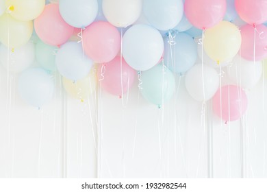 Pastel Colored Balloons On A White Wall