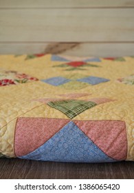 Pastel Colored Folded Patchwork Quilt With Machine Quilting         