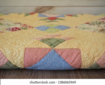 Pastel Colored Folded Patchwork Quilt With Machine Stitching      