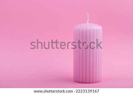 pastel colors background with pink candle on pink background