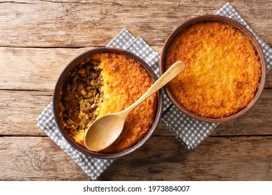 Pastel de choclo corn pie is a Chilean dish based on sweetcorn and beef closeup in the pots on the table. Horizontal top view from above
 - Powered by Shutterstock