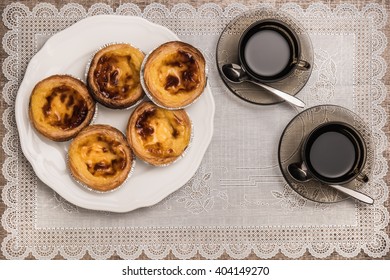 Pastel De Nata, Typical Portuguese Egg Tart Pastries And Black Coffee On A Set Table. Top View With Copy Space