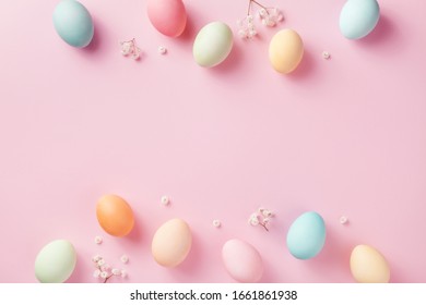 Pastel Easter Eggs On Pink Background Top View. Flat Lay Style.