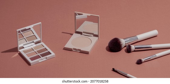 Pastel Eye Shadow Palette, Highlighting Powder And Makeup Brushes On Pink Background.