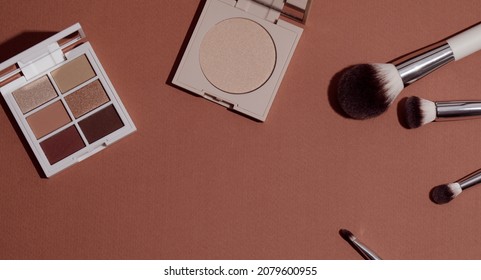 Pastel Eye Shadow Palette, Highlighting Powder And Makeup Brushes On Pink Background.