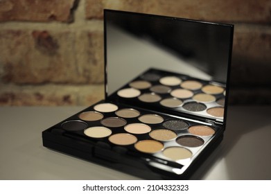 Pastel Eye Shadow Palette On A Brick Wall Background