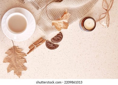 Pastel Feminine Autumn Background - Casual Woman Sweater, Glasess Among Cinnamon Sticks, Candle, Fall Leaves. Aesthetic Coffee Time. Copy Space.