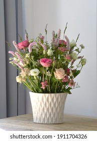 
Pastel Flowers In A White Vase. 
Flower Arrangement For The Table. Pink Flowers