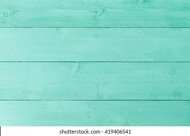 Pastel green stained wood background texture with horizontal parallel boards, woodgrain and copy space, full frame