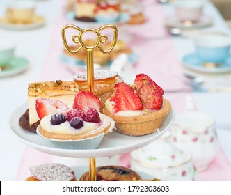 Pastel High Tea Set Up Featuring Pastel Pink, Blue, Yellow And Green Royal Doulton Tea Set And An Assortment Of Cupcakes, Sweets And Pastries.