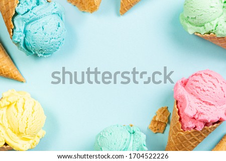 Pastel ice cream in waffle cones, bright background, copy space