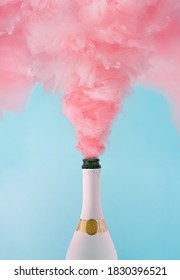 Pastel pink champagne explosion on blue background. Minimal party concept. New Year and Christmas celebration idea.