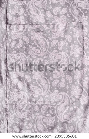 Pastel pink paisley pattern cotton patch pocket closeup as a background