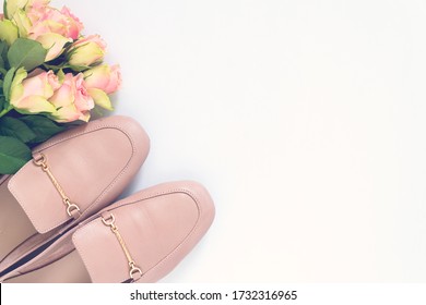 Pastel Pink Women Shoes And Roses On White Background. Pair Of Elegant And Stylish Loafers. Flat Lay, Top View Trendy Fashion Feminine Background. Beauty Blog Concept.