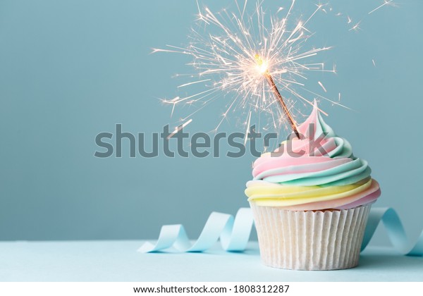 Pastel rainbow\
birthday cupcake with\
sparkler