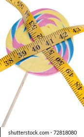 Pastel Rainbow Lollipop Diet Concept With Measuring Tape On White.