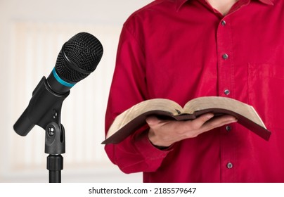 Pastor With A Bible In Hand During A Sermon. The Preacher Delivers A Speech