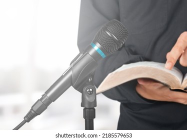 Pastor With A Bible In Hand During A Sermon. The Preacher Delivers A Speech