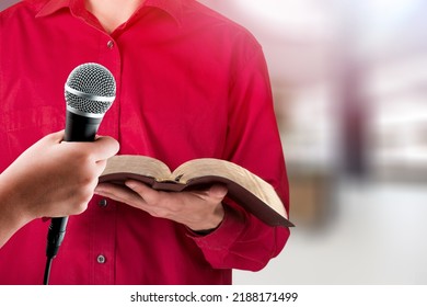 Pastor With A Bible In Hand During A Sermon. The Preacher Delivers A Speech