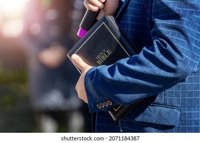 Pastor With A Bible In His Hand During A Sermon. The Preacher Delivers A Speech